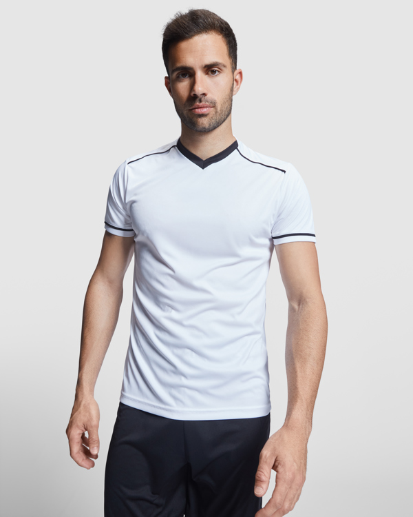 Unisex αθλητική εμφάνιση Roly United 0457 σε λευκό/μαύρο χρώμα, με εκτύπωση λογοτύπου